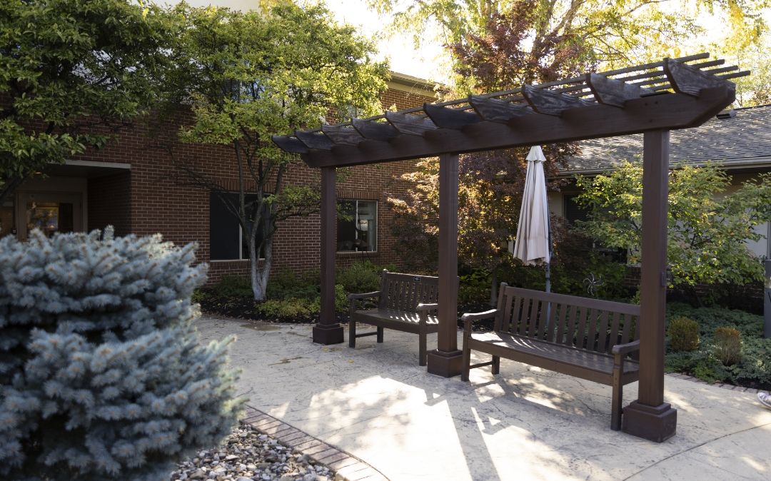 Outdoor pergola patio at Willow Brook Home in Columbus, Ohio, providing a peaceful outdoor space for residents to relax in this senior living community.